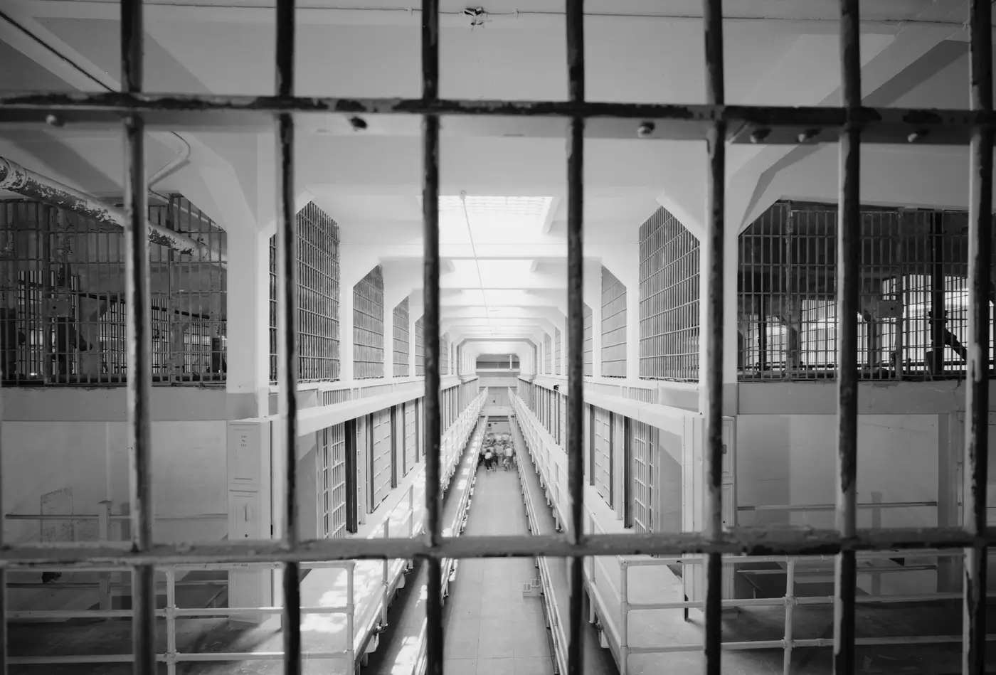 View of the interior of the Alcatraz Island prison in 1986, looking south from the third level guard station with cell block B on the left and cell block C on the right. The island was used as a maximum security federal prison from 1934 to 1963. It housed such notorious criminals as Al Capone, George &quot;Machine Gun&quot; Kelly, Alvin &quot;Creepy&quot; Karpis, Arthur &quot;Doc&quot; Barker, and Whitey Bulger. The FBI helped investigate a famous unsolved escape there in June 1962. Library of Congress photograph.