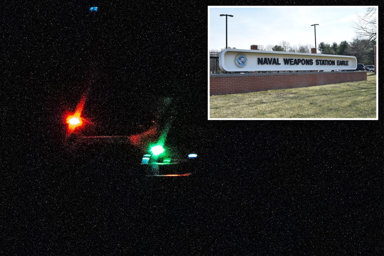 Naval Weapons Station Earle and a helicopter and drone in the night sky